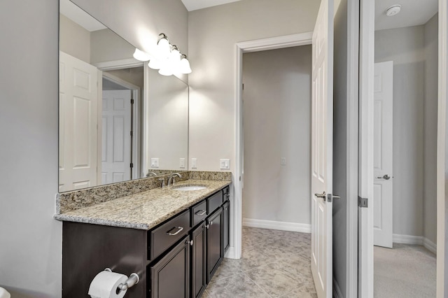 bathroom with tile patterned flooring, vanity, and baseboards