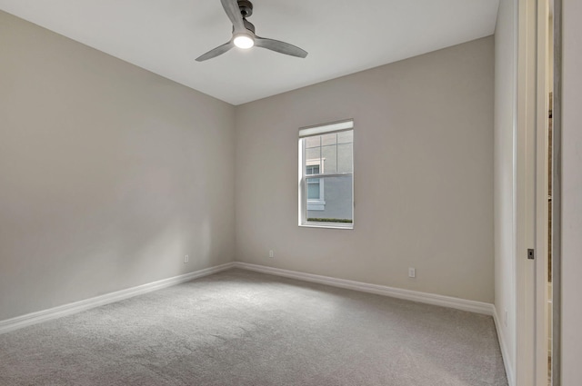 spare room with carpet floors, baseboards, and a ceiling fan