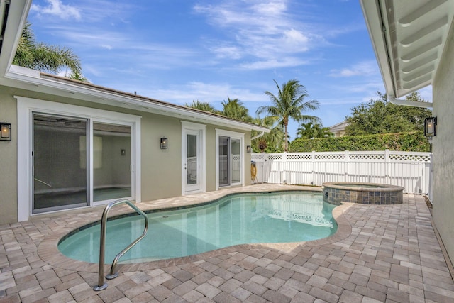 view of swimming pool with an in ground hot tub and a patio area