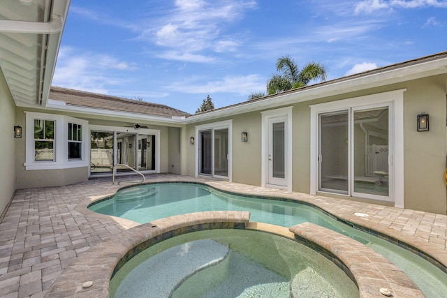 view of swimming pool featuring an in ground hot tub, ceiling fan, and a patio area