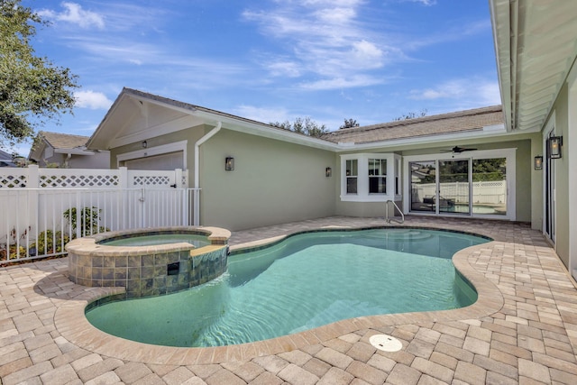 view of pool with an in ground hot tub, ceiling fan, and a patio area