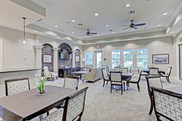 2710 W Mallory Blvd, Jupiter, FL 33458 - dining room with a tray ceiling, a ceiling fan, decorative columns, light colored carpet, and ornamental molding