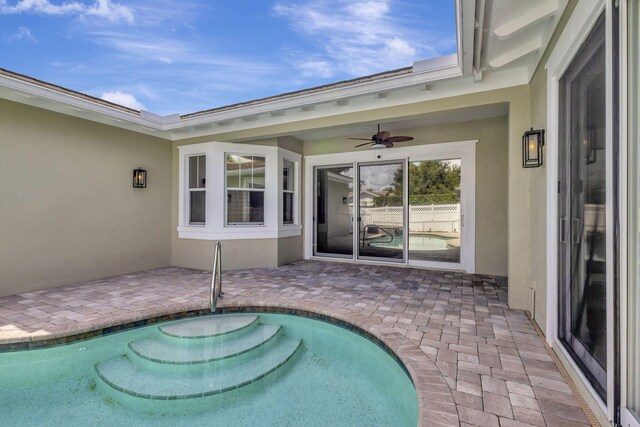 view of swimming pool with a patio and ceiling fan