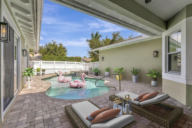 view of patio / terrace featuring a fenced backyard and a pool with connected hot tub