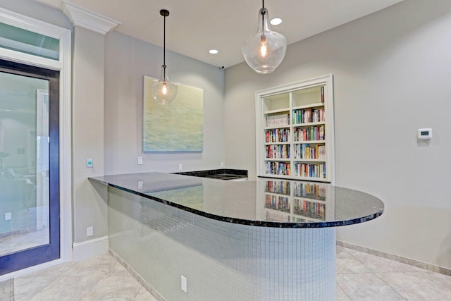 bar with hanging light fixtures, dark stone countertops, and light tile patterned floors