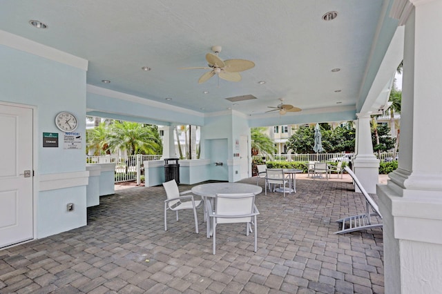 view of patio featuring ceiling fan, fence, and outdoor dining space