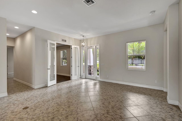 tiled empty room featuring baseboards, visible vents, french doors, and recessed lighting