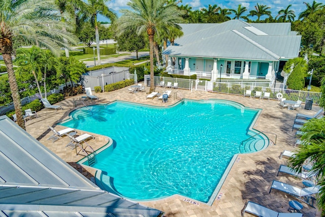 pool featuring fence and a patio