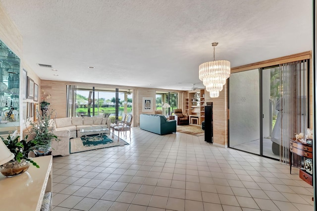 living room with a textured ceiling and a notable chandelier