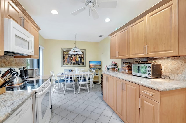 kitchen with ceiling fan, light brown cabinets, hanging light fixtures, white appliances, and light stone countertops