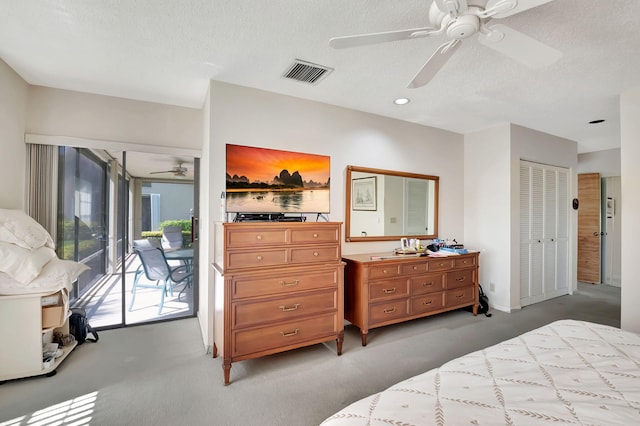 bedroom with ceiling fan, a textured ceiling, a closet, light colored carpet, and access to exterior