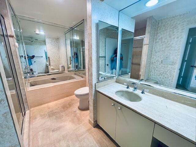 full bathroom featuring vanity, shower with separate bathtub, and toilet