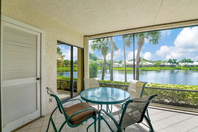 sunroom / solarium with a water view