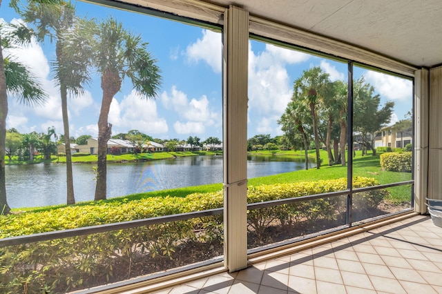 unfurnished sunroom with a water view and a wealth of natural light