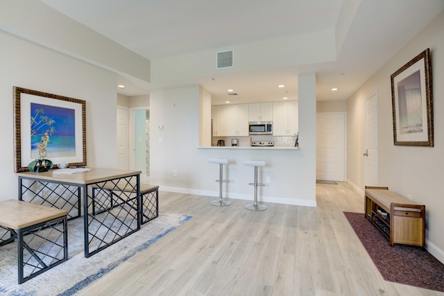 1203 Town Center Dr Unit 313, Jupiter, FL 33458 - hallway with baseboards, visible vents, recessed lighting, and light wood-type flooring