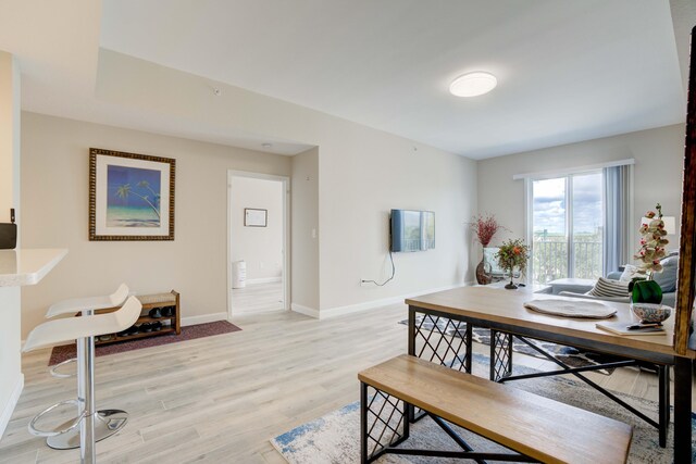 dining space with light hardwood / wood-style flooring