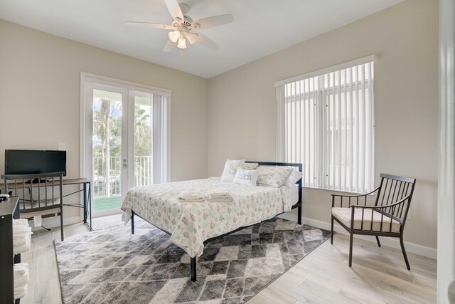 bedroom featuring ceiling fan, french doors, light wood-type flooring, and access to outside