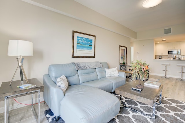 1203 Town Center Dr Unit 313, Jupiter, FL 33458 - living area featuring baseboards, visible vents, and light wood finished floors