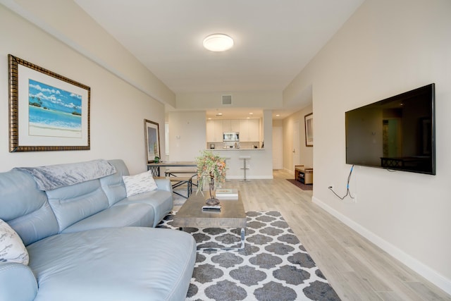 living room with light hardwood / wood-style floors