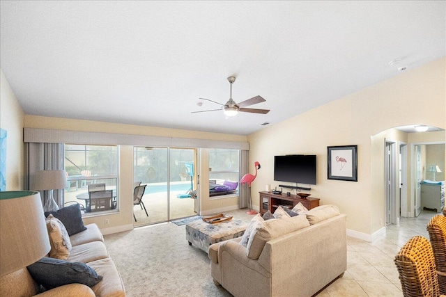 tiled living room featuring ceiling fan, a wealth of natural light, and vaulted ceiling