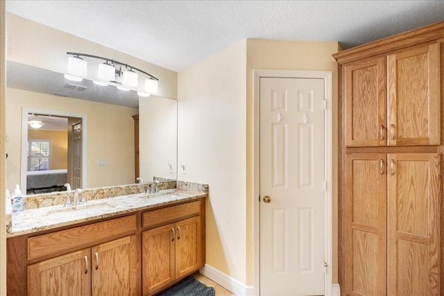 bathroom featuring vanity and a textured ceiling