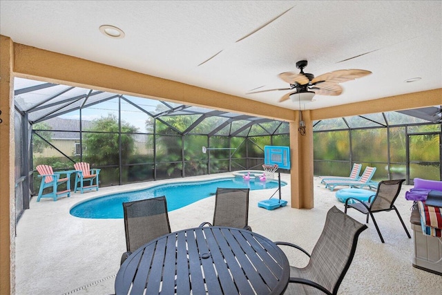 view of pool with a lanai, ceiling fan, and a patio