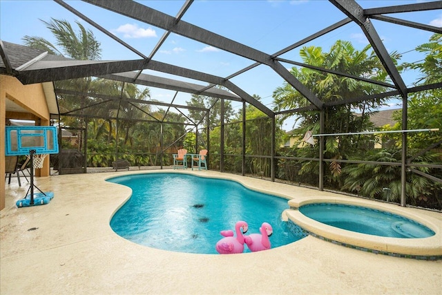 view of swimming pool featuring glass enclosure, an in ground hot tub, and a patio