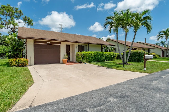 single story home with a front yard and a garage