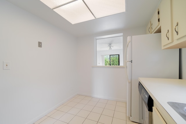 kitchen with ceiling fan, light tile patterned flooring, cream cabinetry, and dishwashing machine