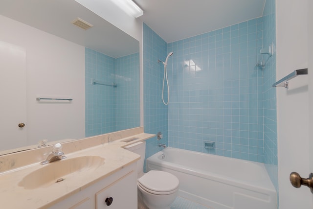 full bathroom with vanity, tiled shower / bath combo, toilet, and tile patterned flooring