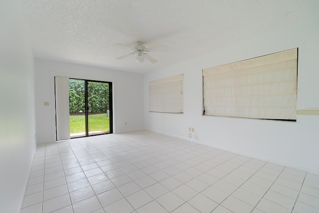 tiled spare room with ceiling fan and a textured ceiling