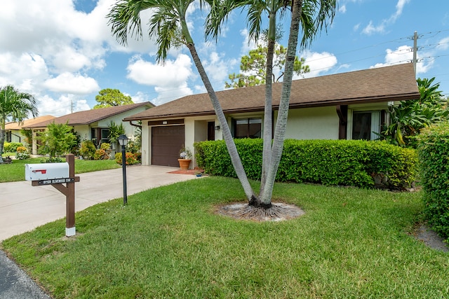 ranch-style house featuring a front lawn and a garage