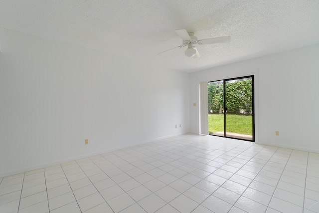 tiled empty room with ceiling fan and a textured ceiling