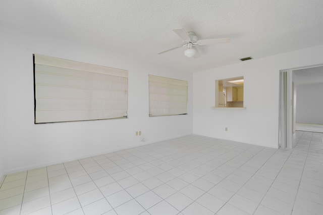 unfurnished room with light tile patterned floors and ceiling fan