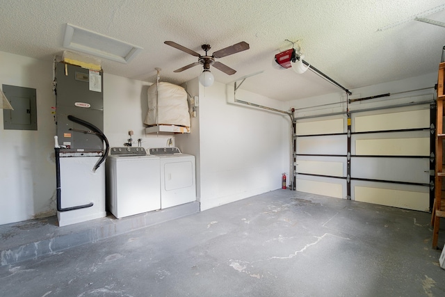 garage with electric panel, ceiling fan, heating unit, a garage door opener, and washer and clothes dryer