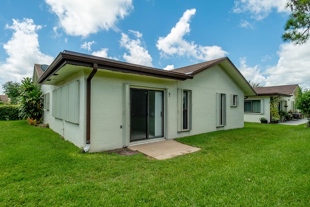 rear view of property with a yard