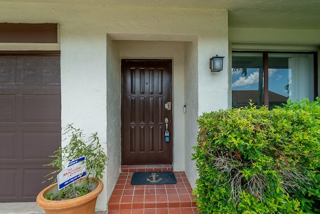 doorway to property with a garage