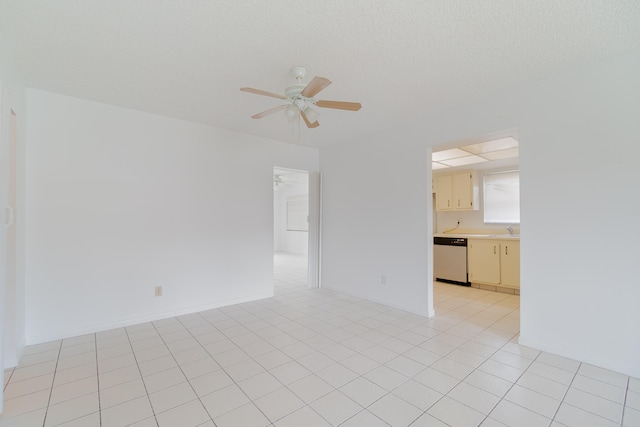 unfurnished room featuring light tile patterned floors, sink, and ceiling fan