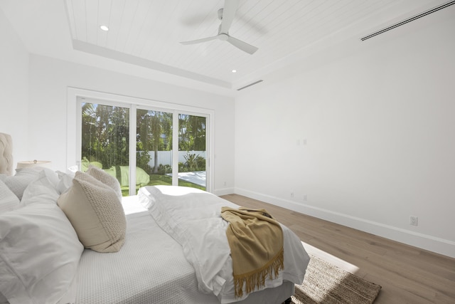 bedroom featuring access to exterior, ceiling fan, and hardwood / wood-style floors