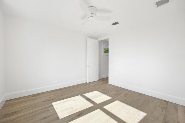 empty room featuring ceiling fan and light hardwood / wood-style floors