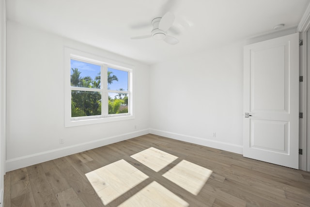 empty room featuring ceiling fan and hardwood / wood-style flooring