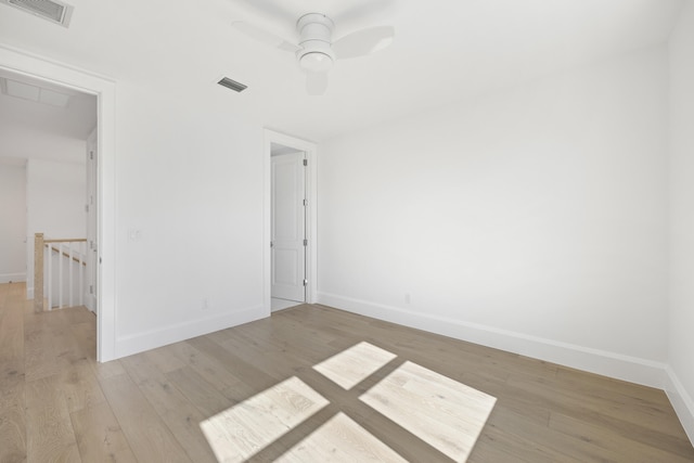 spare room featuring ceiling fan and light hardwood / wood-style floors