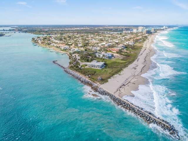 birds eye view of property with a beach view and a water view