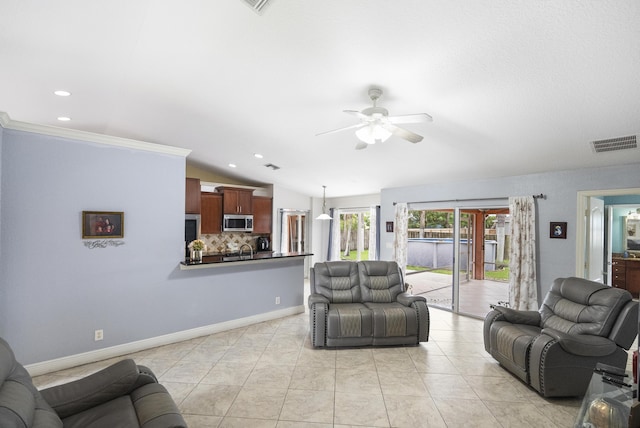 living room with ceiling fan, sink, light tile patterned floors, and vaulted ceiling