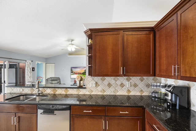 kitchen featuring ceiling fan, dishwasher, dark stone counters, vaulted ceiling, and sink