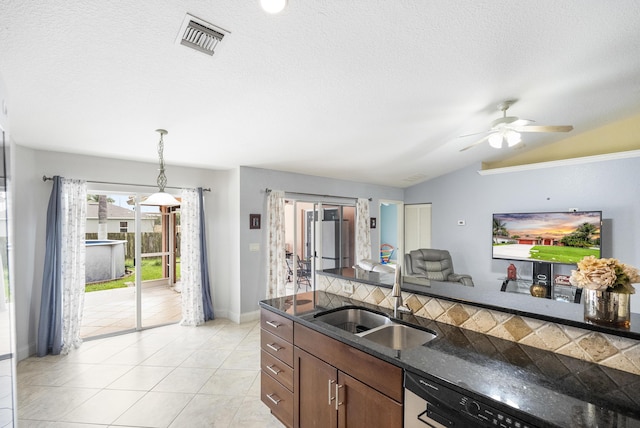 kitchen featuring lofted ceiling, black dishwasher, sink, hanging light fixtures, and ceiling fan