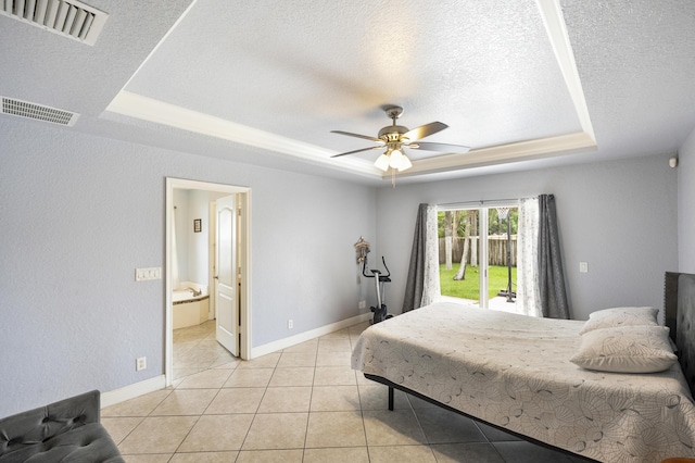 bedroom with access to exterior, a raised ceiling, light tile patterned flooring, ceiling fan, and ensuite bathroom