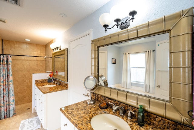 bathroom featuring a shower with shower curtain, tile patterned floors, and vanity