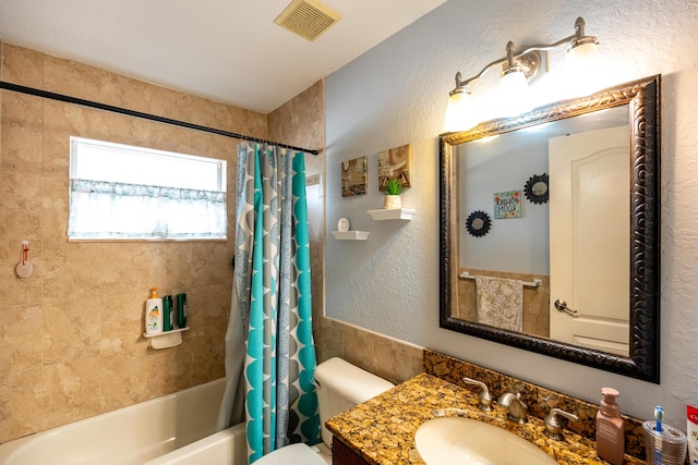 full bathroom with toilet, vanity, and shower / tub combo with curtain