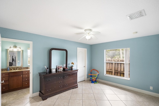 bedroom with ceiling fan, sink, ensuite bathroom, and light tile patterned flooring